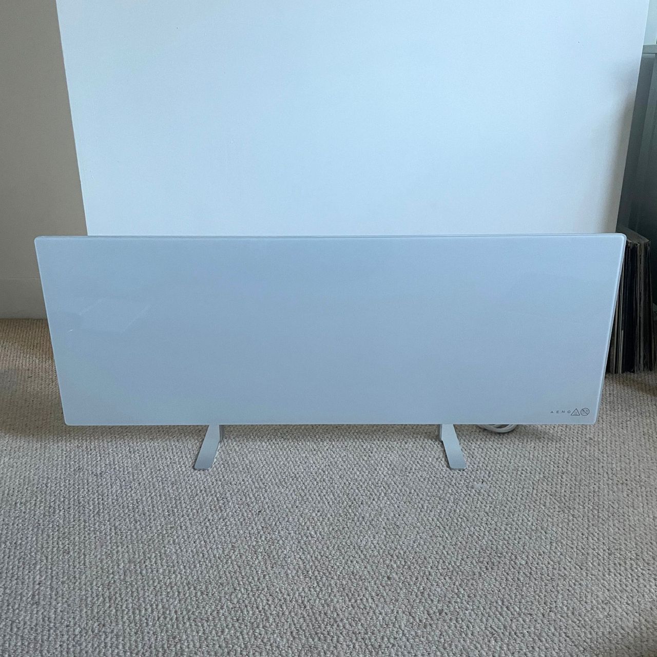 Freestanding Aeno Premium Eco Smart Heater in front of a white painted wall