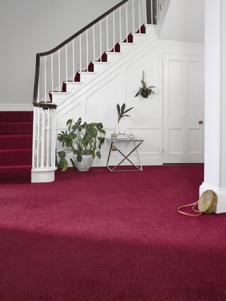 Hallway and staircase with red carpet from Abingdon Flooring