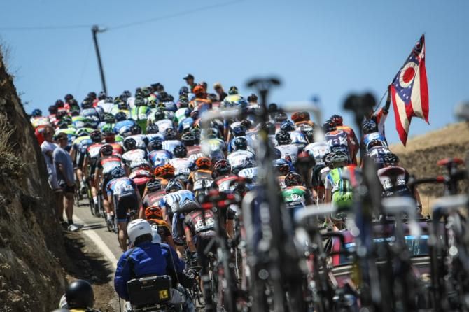 The peloton bunches up on a climb.