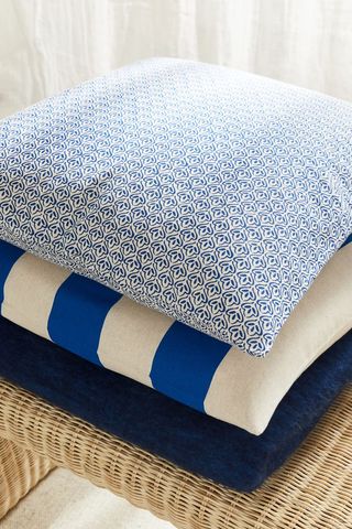 three blue patterned cushions stacked on top of each other