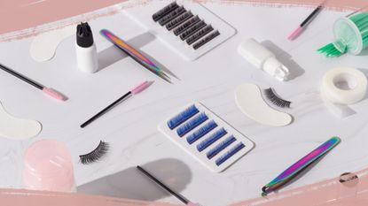 All the tools you need to learn how to apply false eyelashes on a marble surface including tweezers, lashes, glue, spoolie