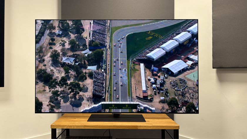 The 65-inch LG G5 OLED TV pictured on a wooden rack. On the screen is a still from Netflix F1 series Drive to Survive.