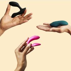 3 hand holding different types of vibrators on a cream background