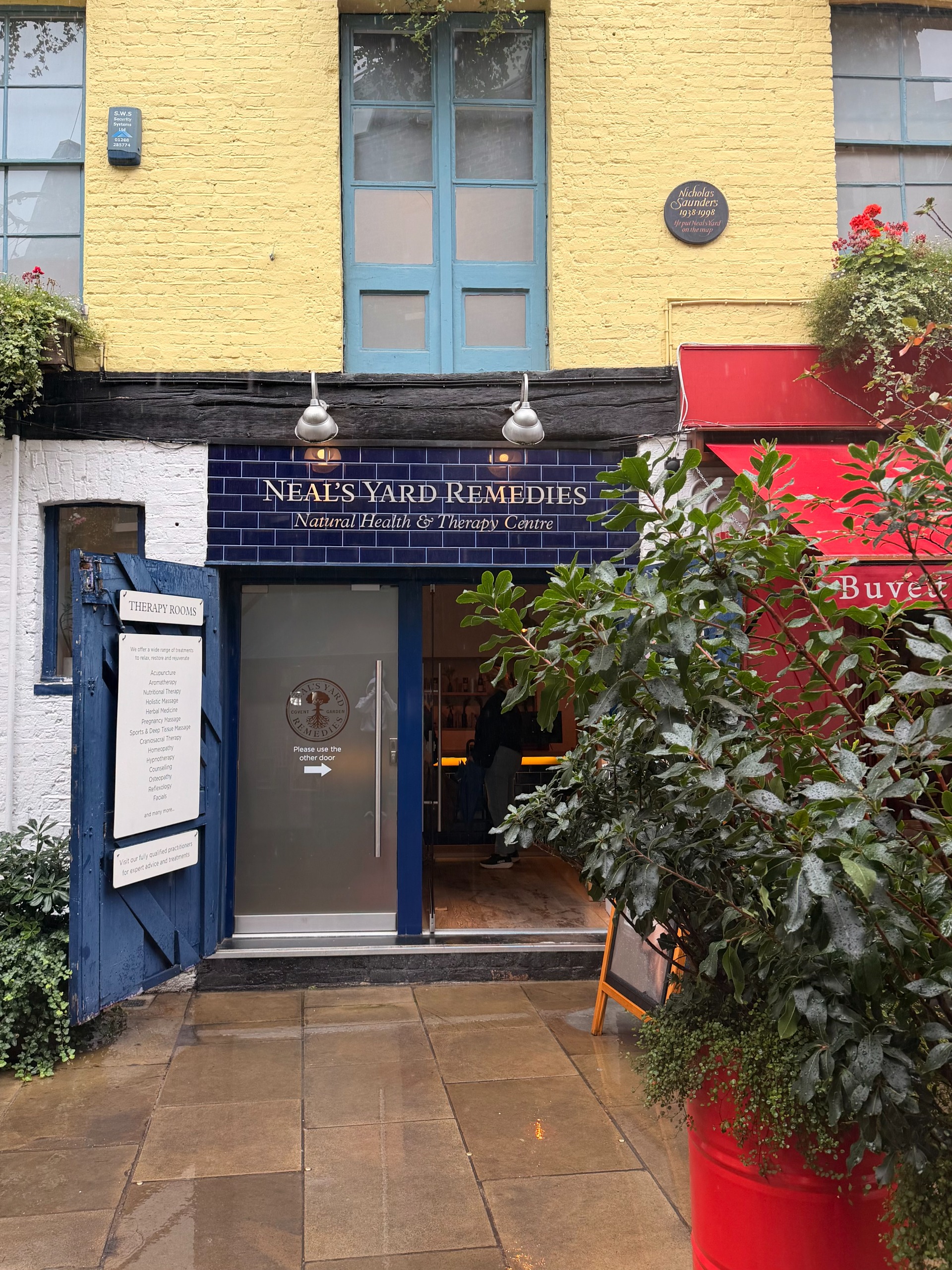 A shop front in a leafy courtyard