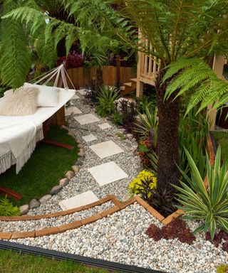 hammock in garden with gravel path and stones