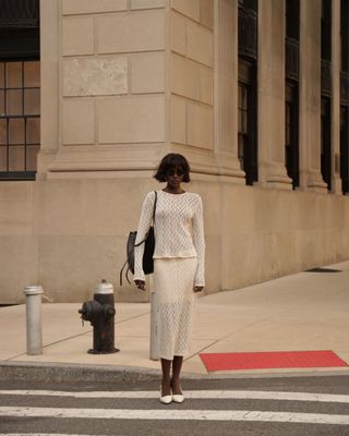 Influencer wears white slingbacks.