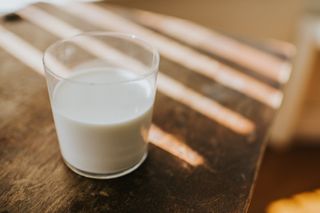 Image shows a glass of milk.