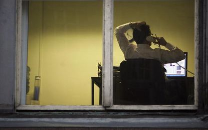 An employee working late in an office.