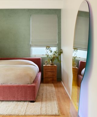 green and pink modern bedroom with a large floor mirror