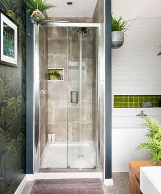 bathroom with white wall palm tree designed wallpaper shower cabin and plants
