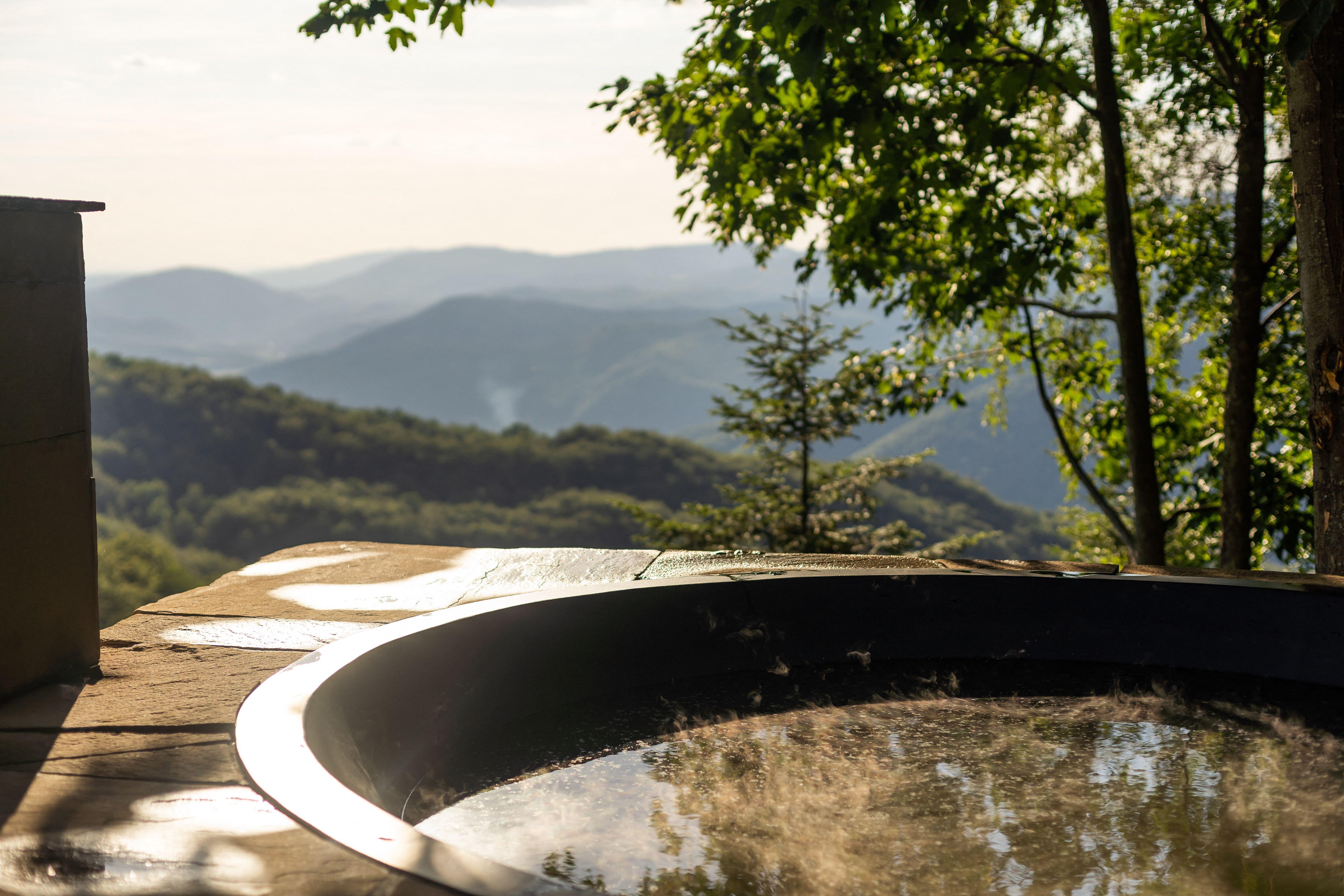 An empty hot tub with a view over a valley