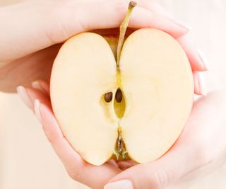 apple fruit sliced in two showing core and seeds