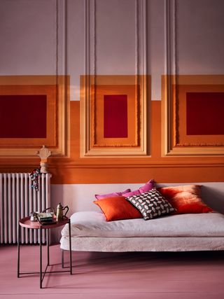 brightly colored orange and red living room by Annie Sloan