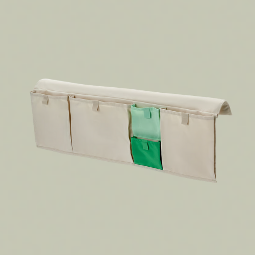 A beige bed pocket organizer with one green colored pocket