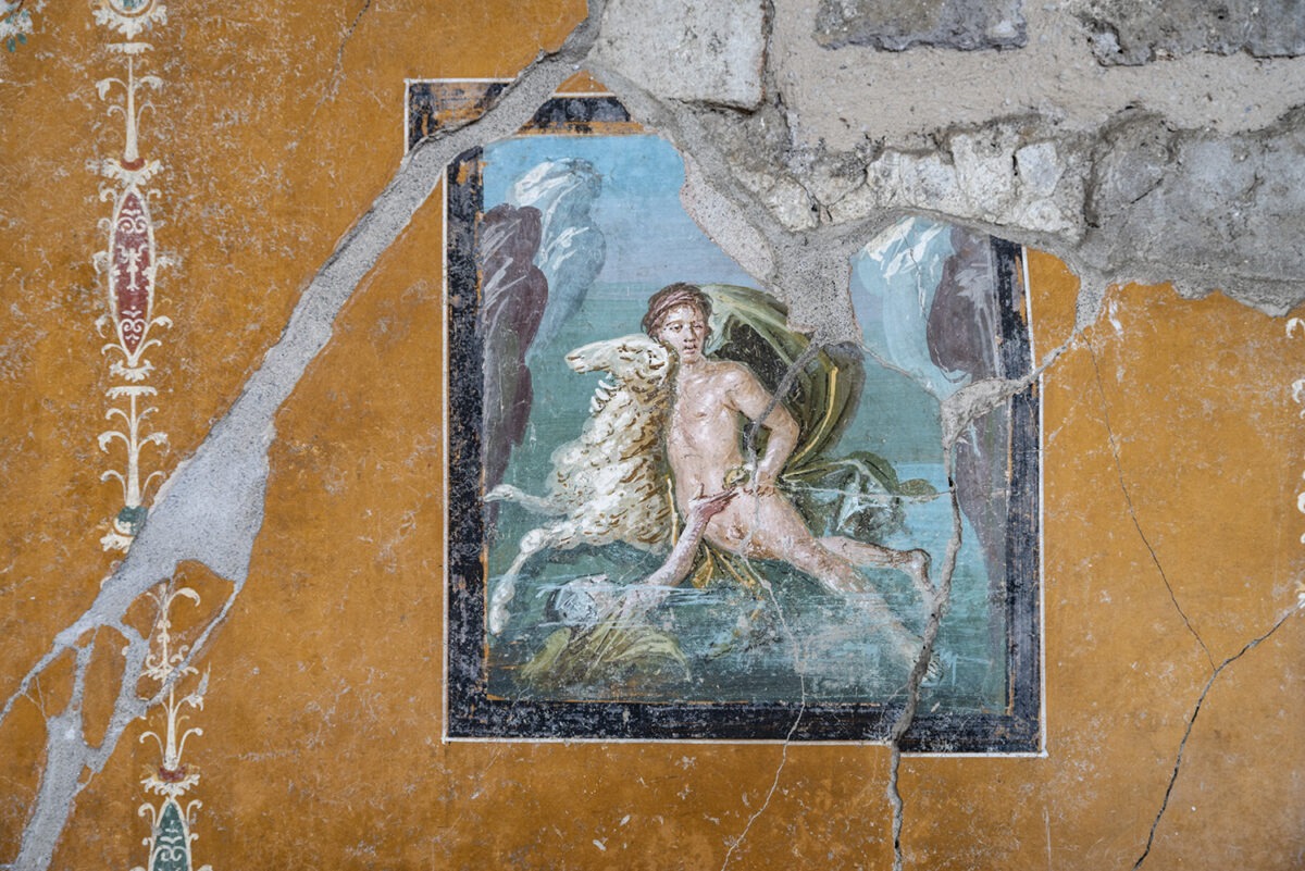 a wall painting of a boy with wings and a ram