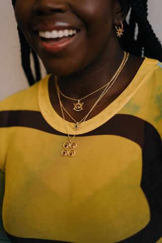 model wearing layered gold necklaces