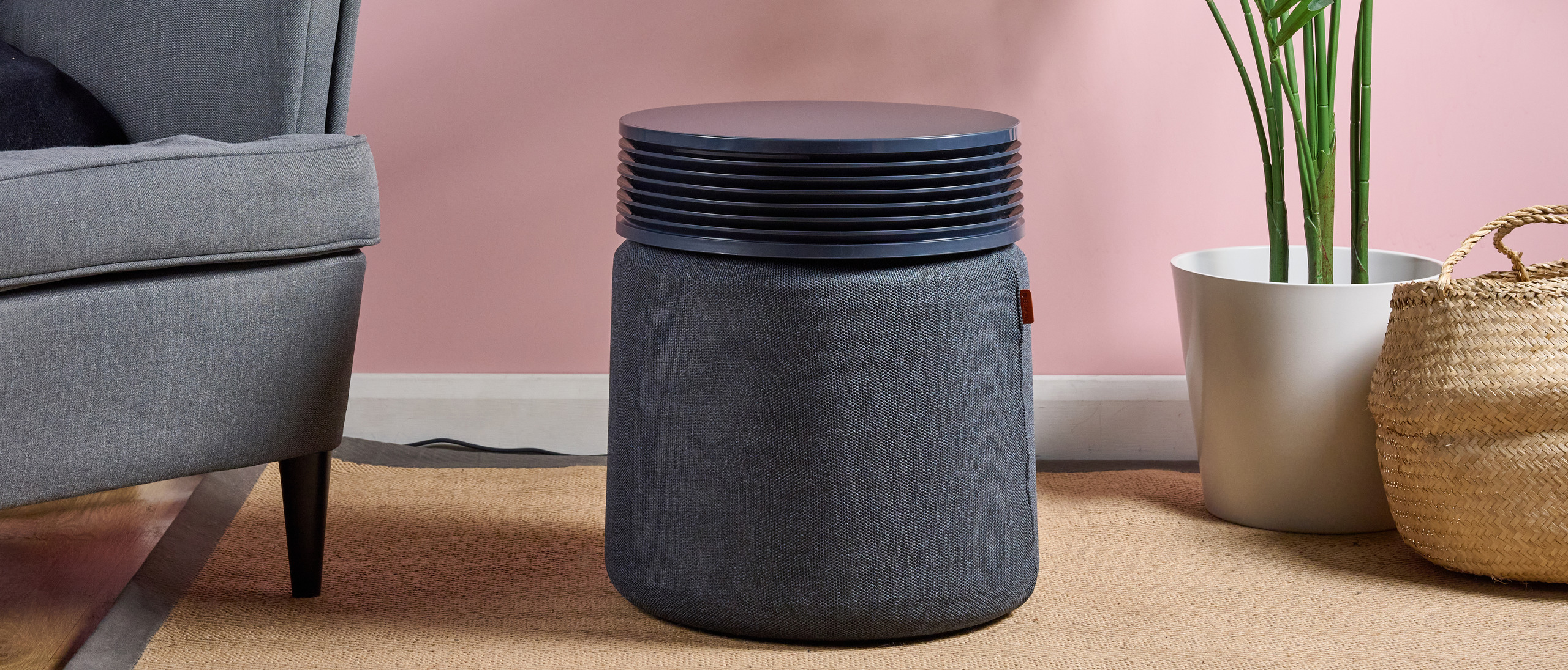 The Blueair Blue Signature air purifier is pictured in a pink living room.