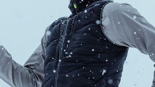 Mountain runners in winter wearing the Hoka Skyfall vest