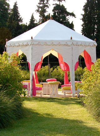 garden pavilion made from white canvas with pink curtains