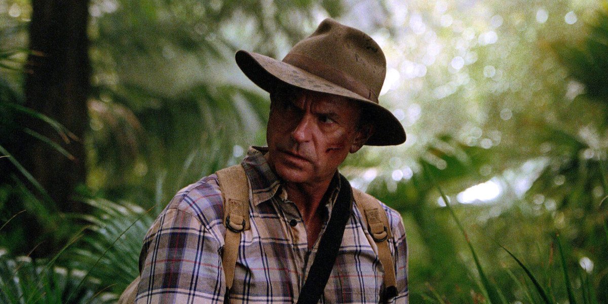 Dr. Grant (Sam Neill) walks through the woods in a scene from Jurassic Park III.