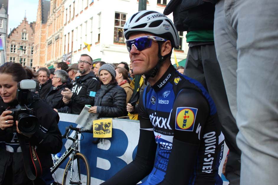 Stijn Vandenbergh sits on the photographer's podium to the left of the start line