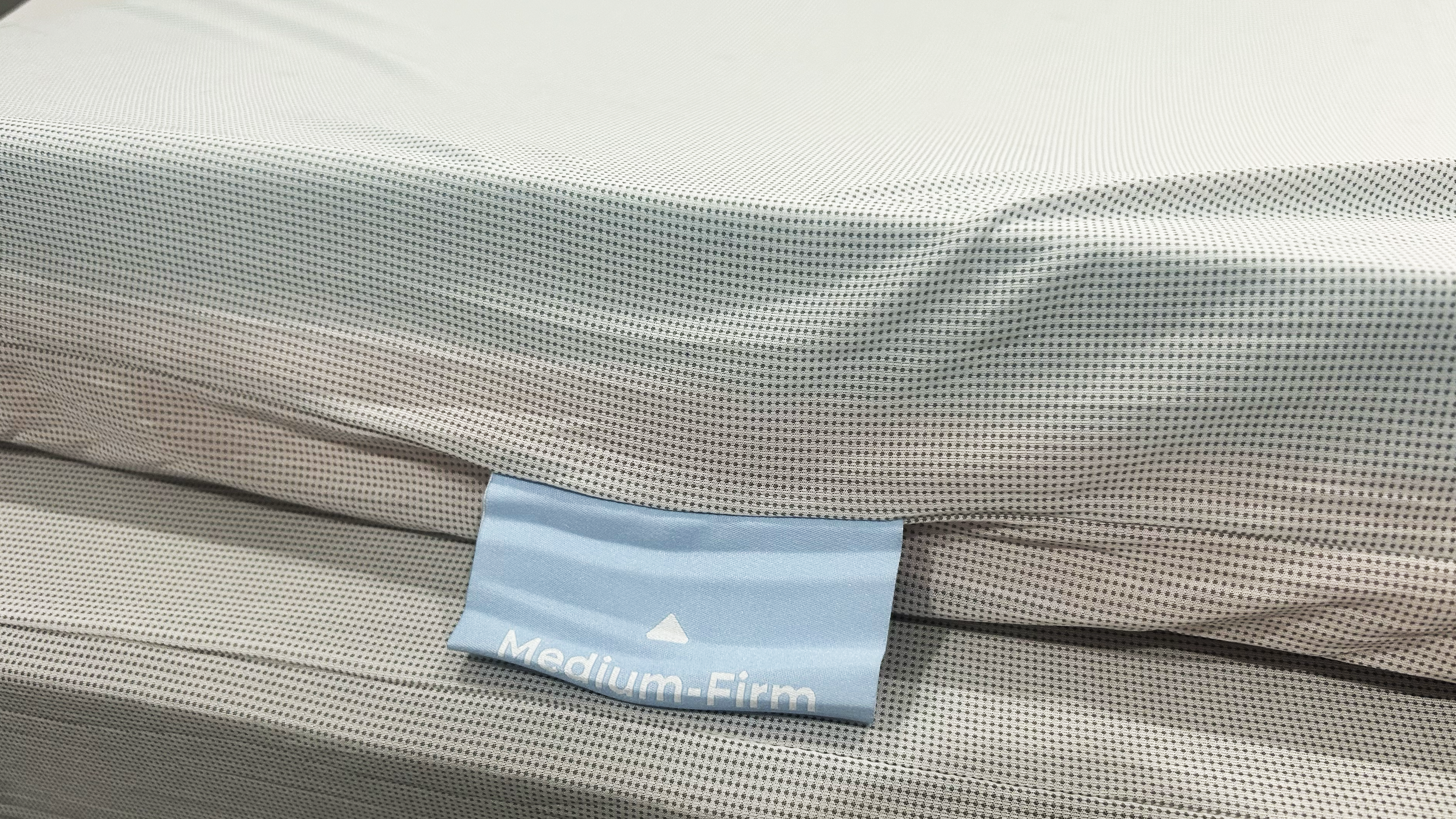 Medium firm tag on mesh liner of mattress