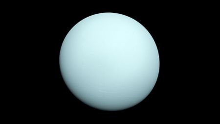 A light blue planet set against the darkness of space