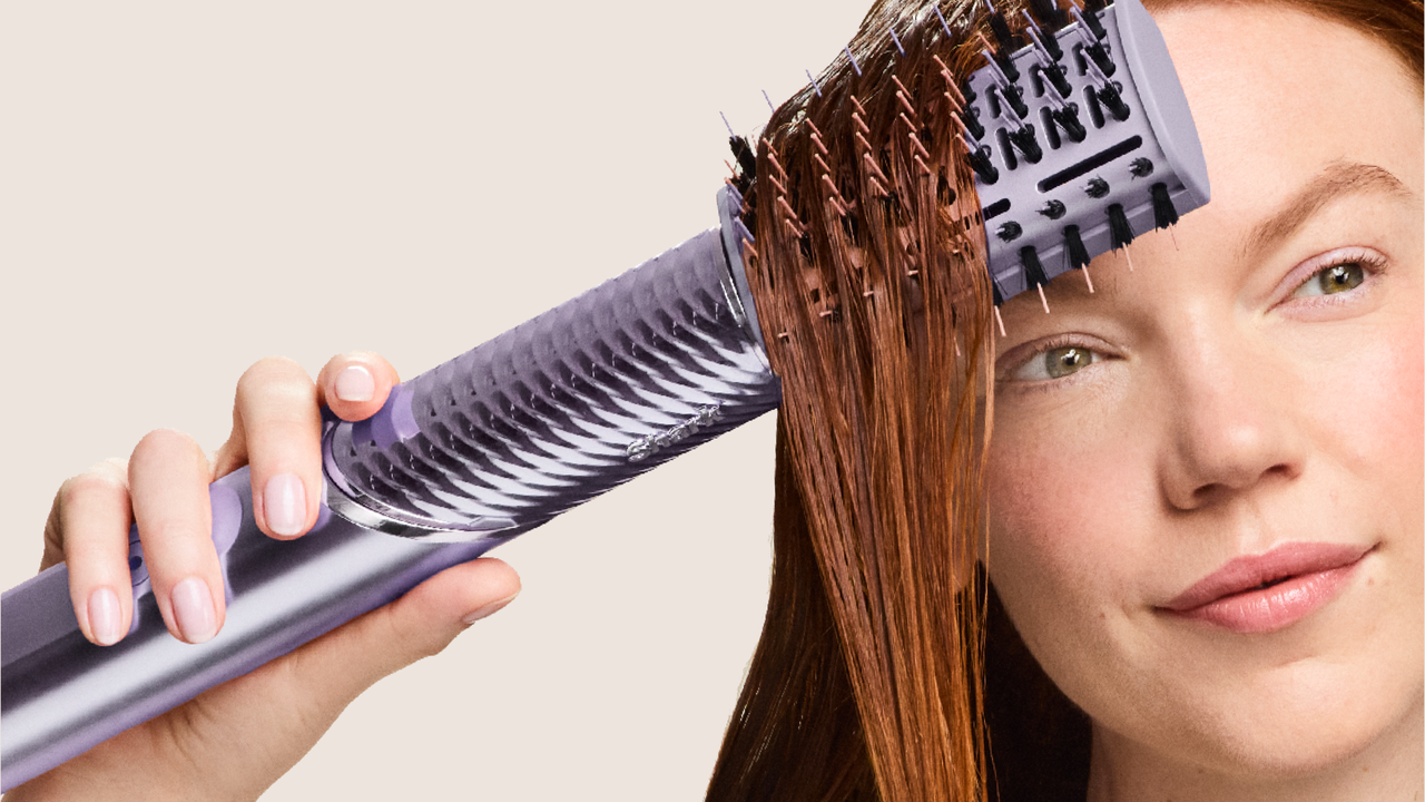 Woman styling hair using Shark FlexStyle IonCurl
