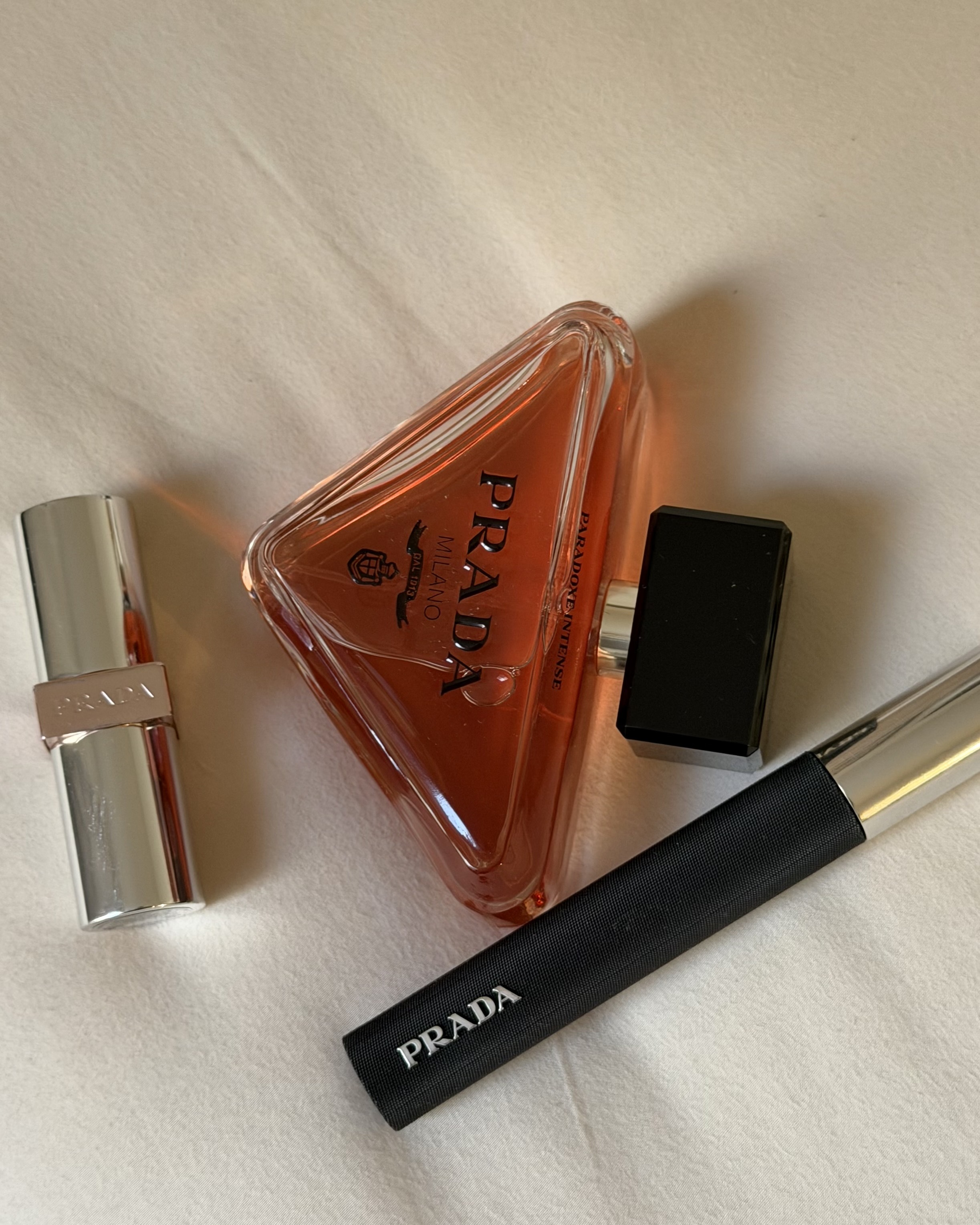 An image of WWW associate beauty editor Alyssa Brascia's Prada Beauty mascara, lip product, and mascara.