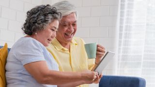 An older couple look through various Medicare plans on a tablet