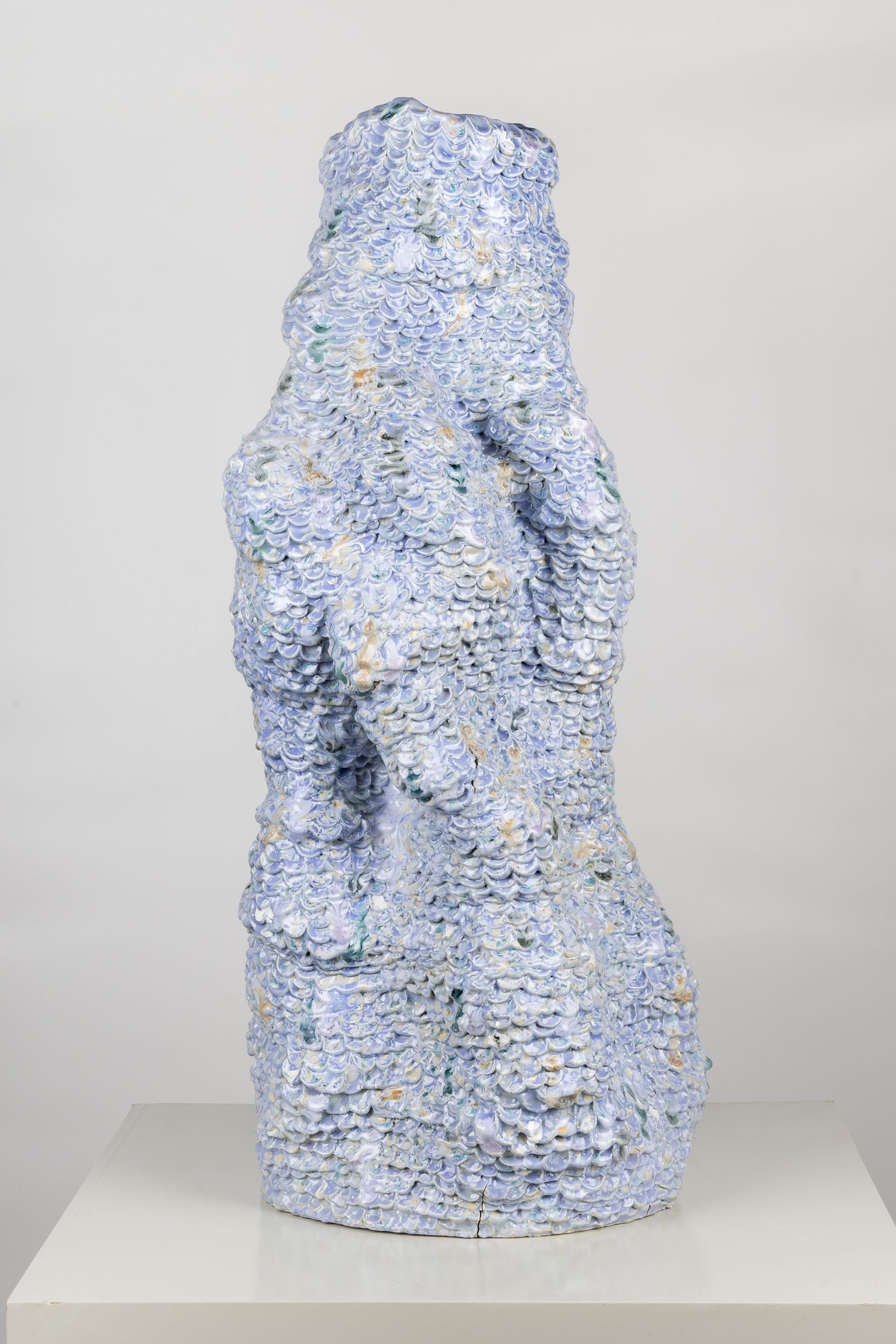 sculptural pale blue vessel, vaguely in form of hand gripping