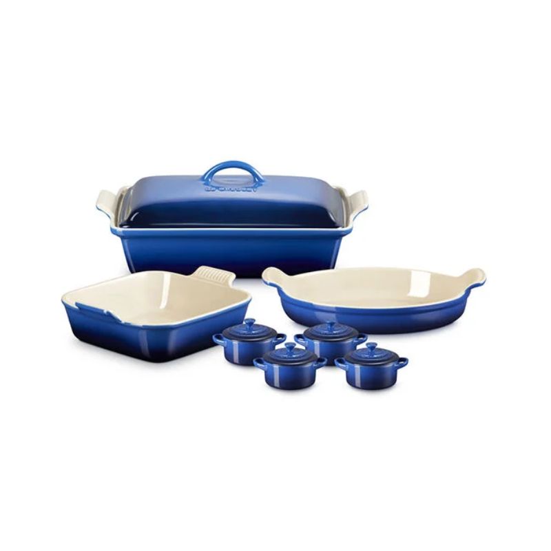 8-piece blue Le Creuset set including pie dishes, mini cocottes, and a covered casserole dish