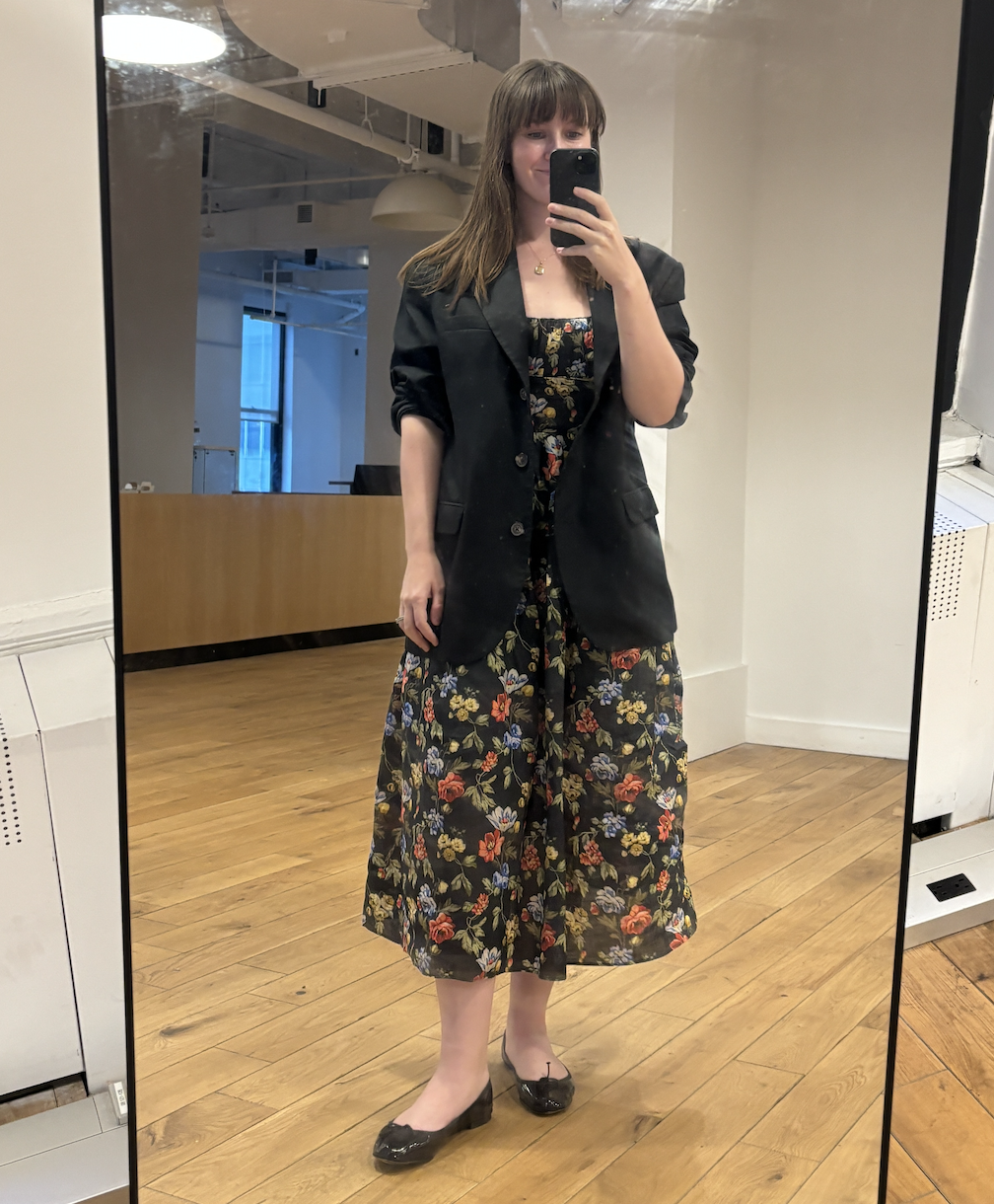 an editor taking a mirror selfie wearing a doen dress