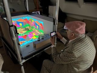 David Hockney viewing the model box containing "August 2021, Landscape with Shadows" Twelve iPad paintings comprising a single work