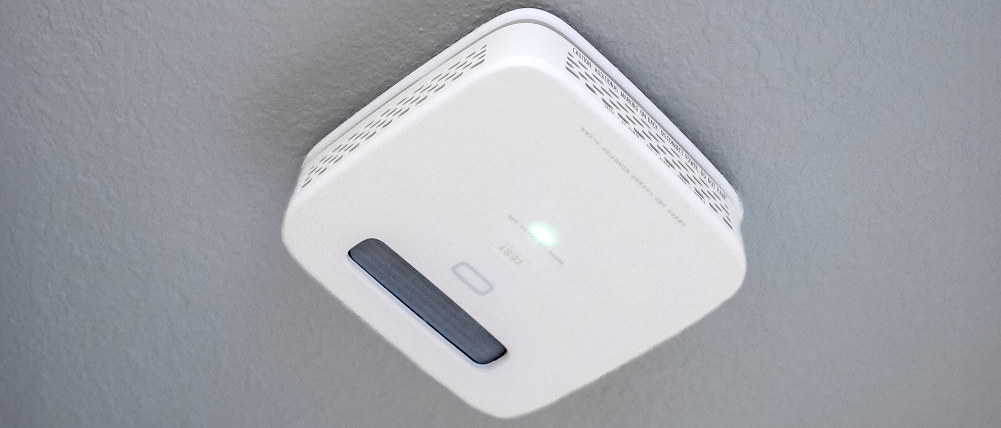 A Place smoke alarm mounted on the ceiling