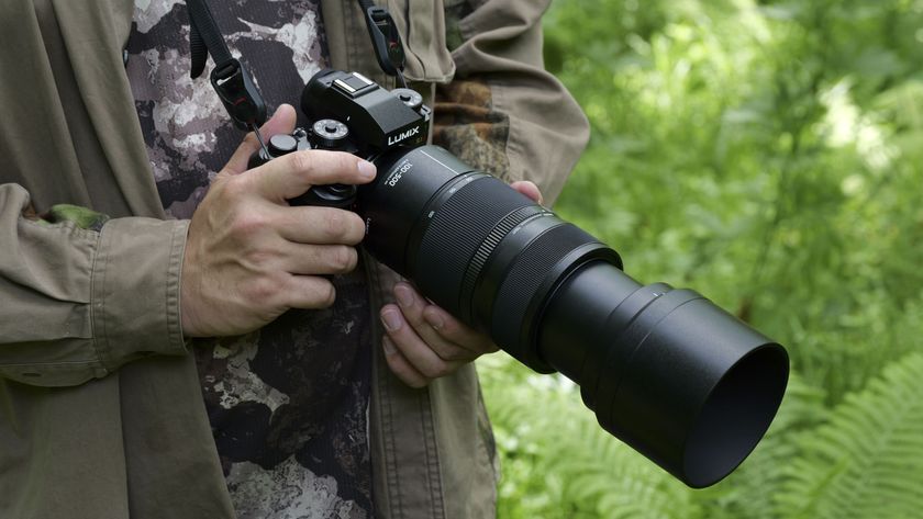 Panasonic Lumix S 100-500mm F5-7.1 O.I.S lens attached to a Lumix S1 II, in photographer&#039;s hands