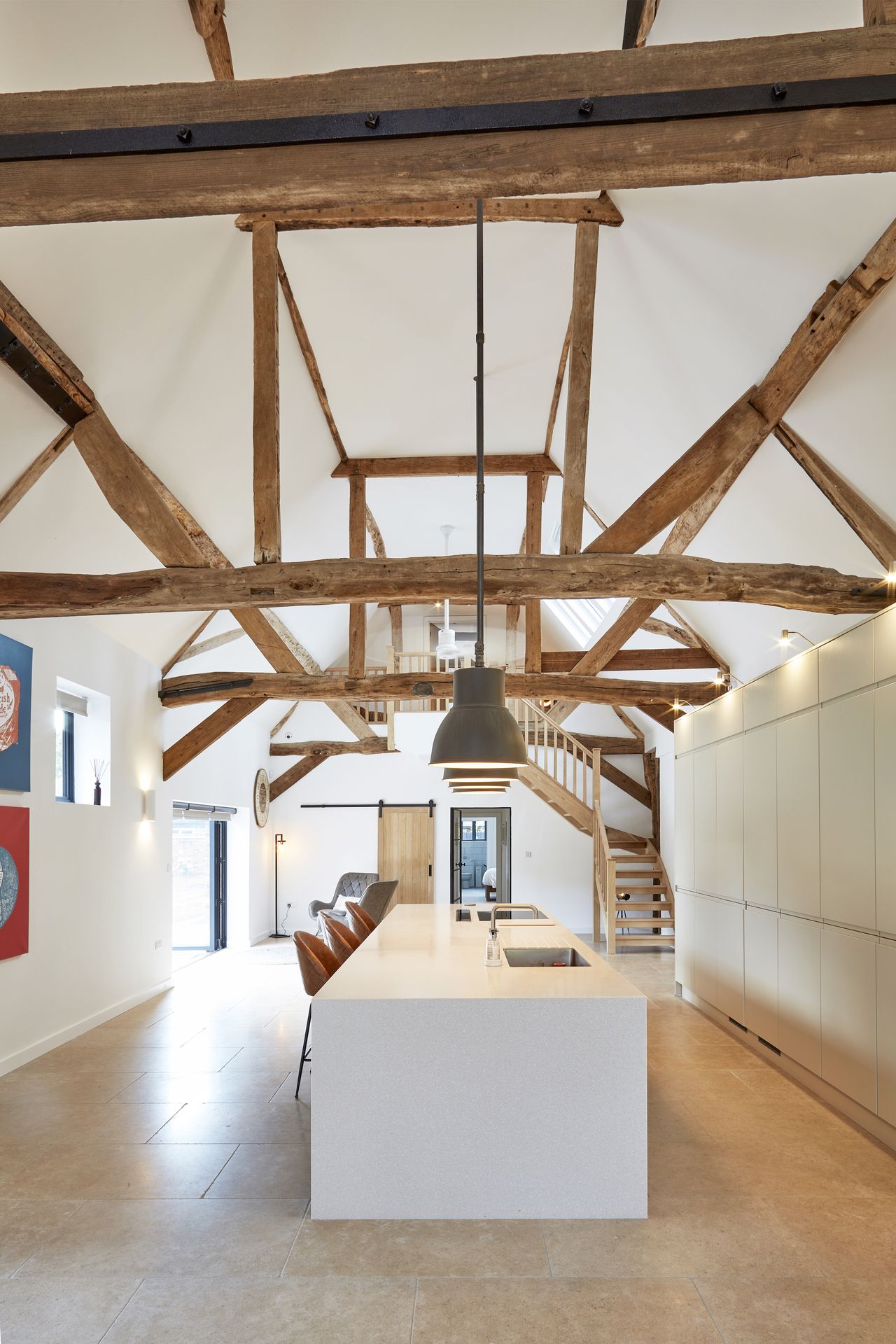 large white kitchen with exposed beams above