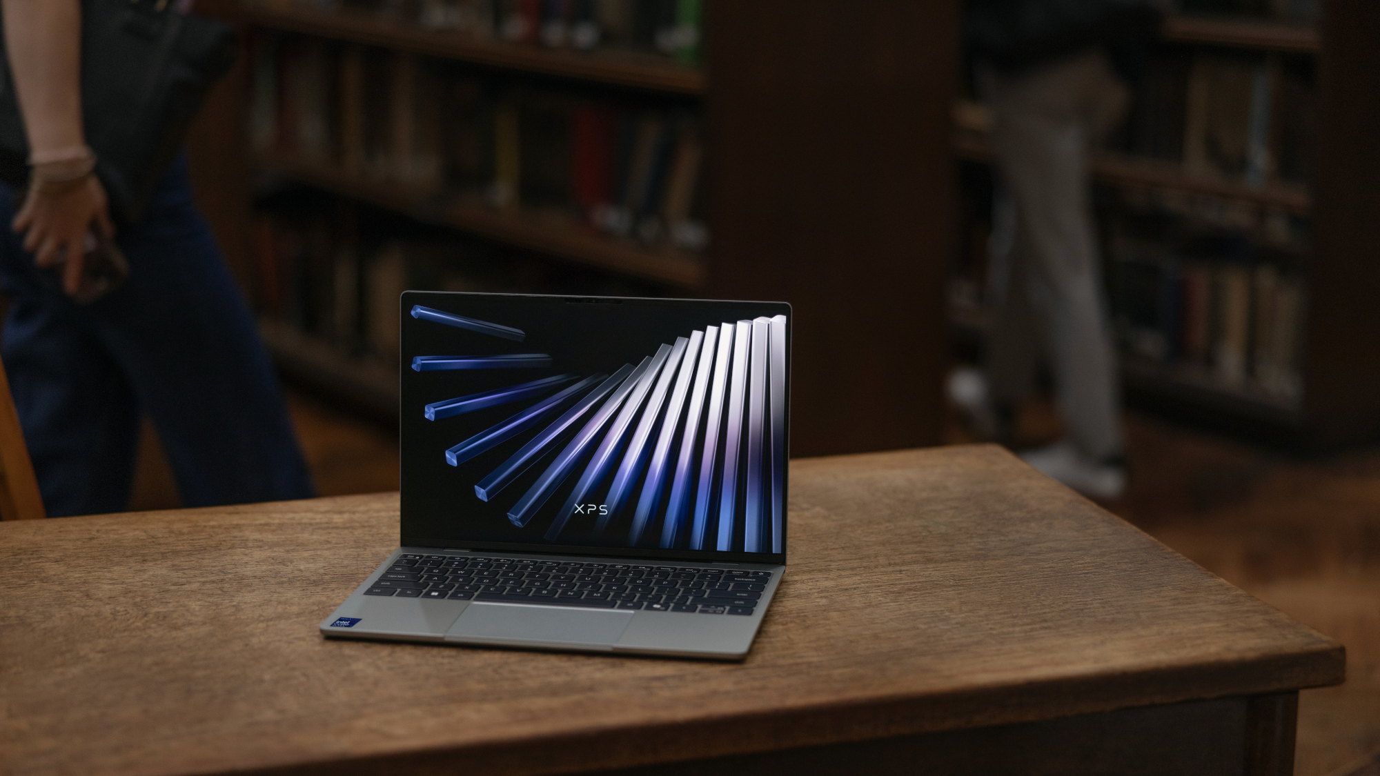 Dell XPS 13 laptop on a desk in a library