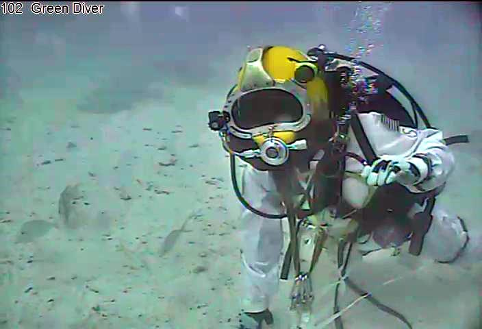 astronaut Shannon Walker maneuvers around the simulated asteroid floor