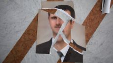 A torn portrait of Bashir al-Assad