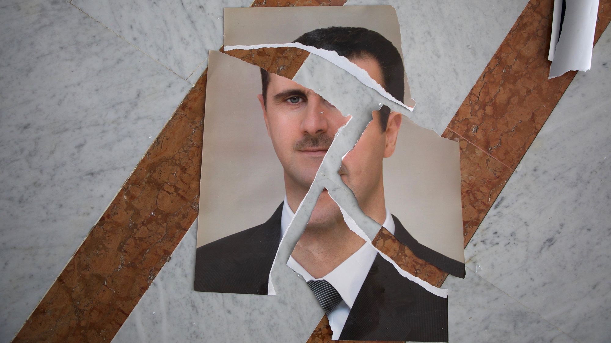 A torn portrait of Bashir al-Assad