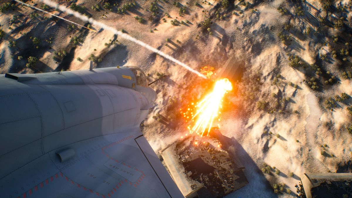 Ace Combat 8 screenshot showing a plane flying toward the ground with an explosive setting off