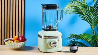 The KitchenAid K400 blender photographed in front of a blue background.