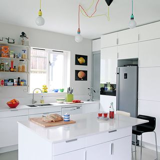 kitchen area with white wall and white kitchen units