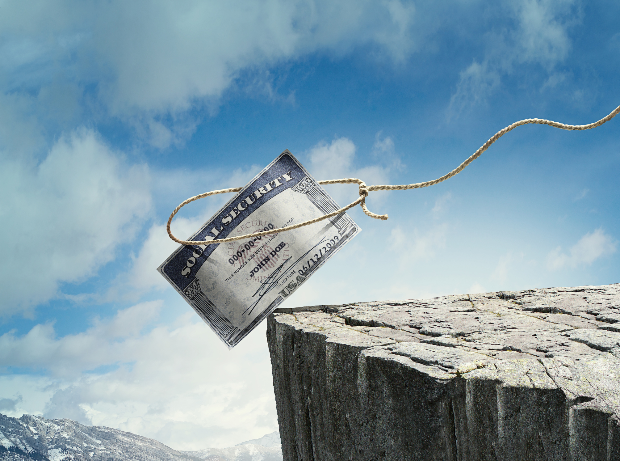 Social security card is teetering on side of cliff 