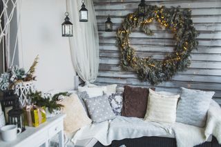 festive balcony with cushions and throws and a large light up wreath