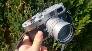 Leica M2 being held in someone's hand outdoors