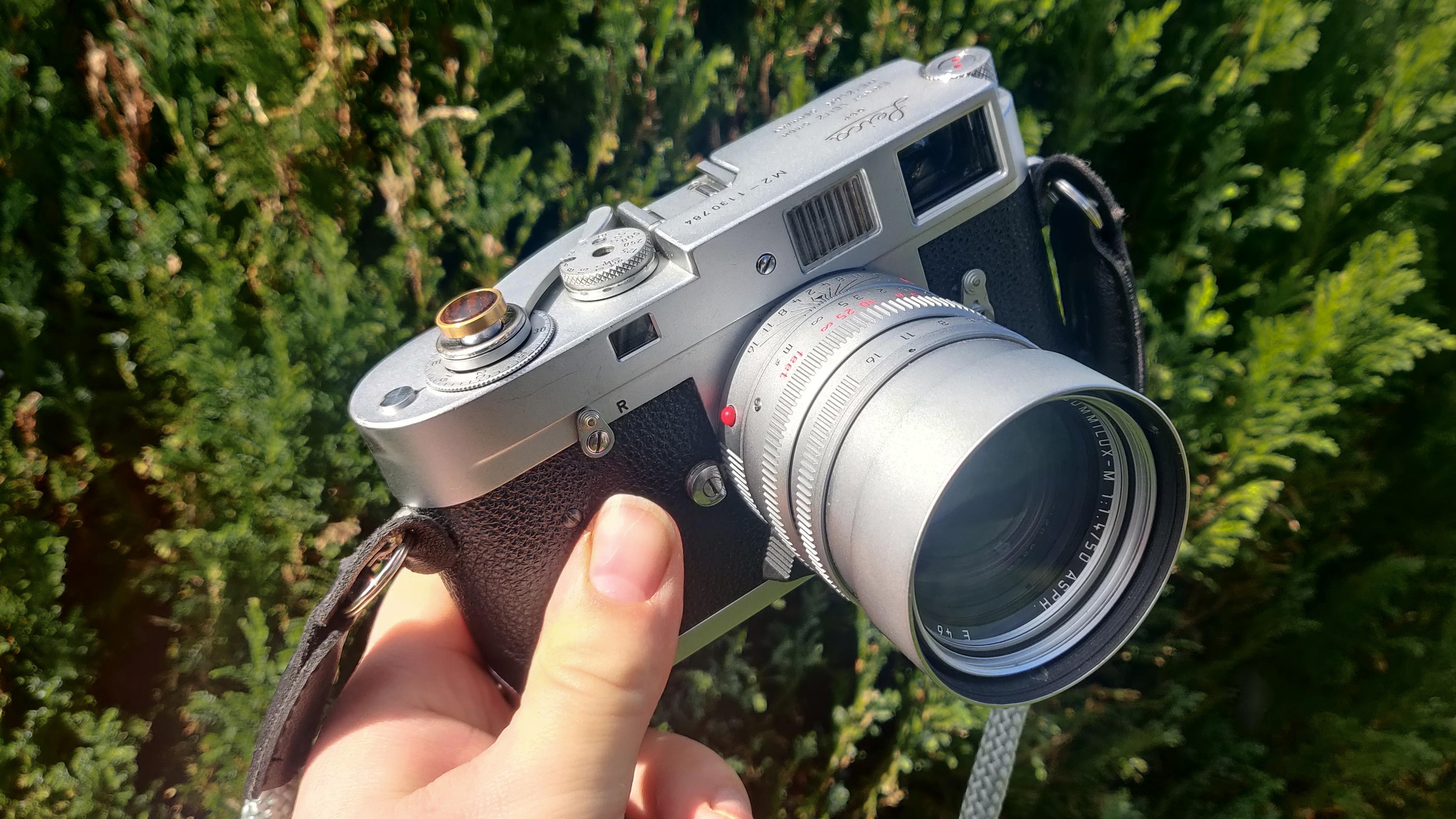 Leica M2 being held in someone&#039;s hand outdoors