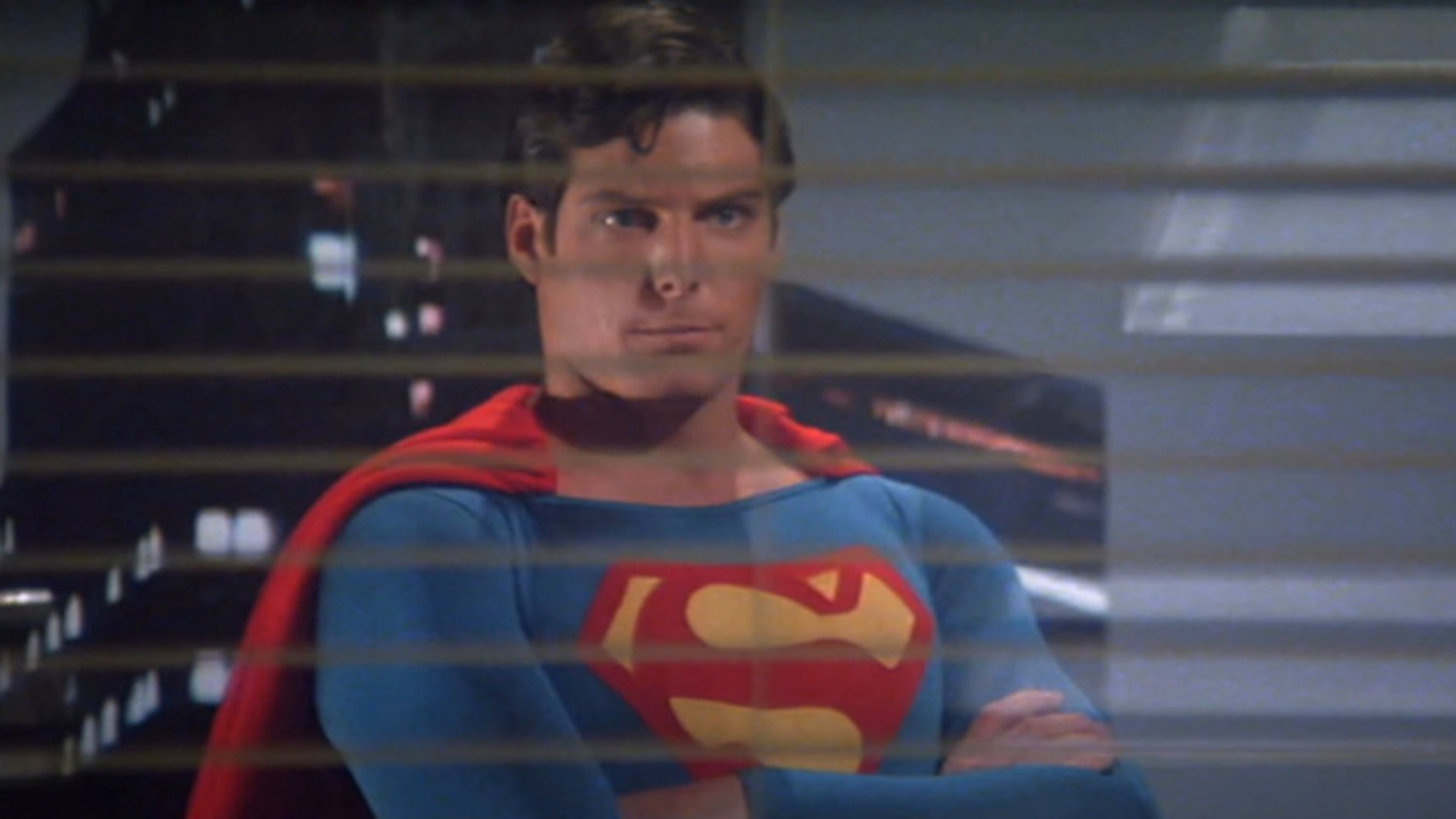 Christopher Reeve as Superman looking into a window while flying during a scene in the movie Superman 2.