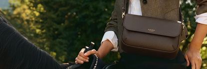 Woman wearing Aspinal bag on a horse